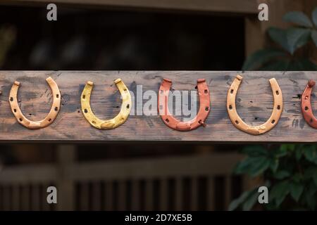 Lucky horseshoe hanging on the wooden board. horseshoes for horses Stock Photo