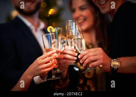 Two beautiful young couples having fun at New Year's Eve Party Stock Photo