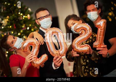Two beautiful young couples having fun at New Year's Eve Party Stock Photo