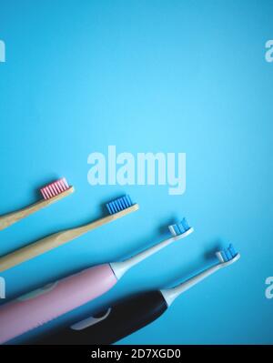 two ultrasonic electric toothbrushes on a blue background Stock Photo