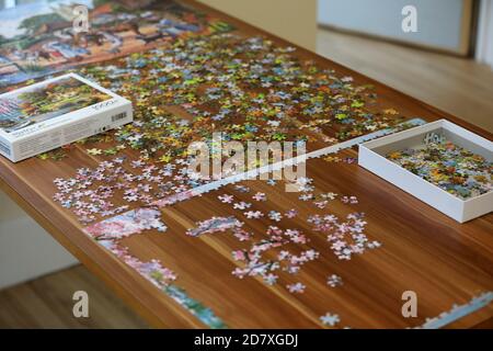 Men in an old peoples home doing a puzzle, Sussex, UK. Stock Photo