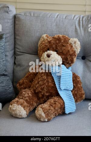 A big teddy bear pictured sat on a sofa in Hampshire, UK. Stock Photo