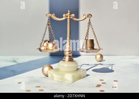 Cost of Christmas holidays concept. Weight scales, vintage balance with stack of coins on marble. Stock Photo