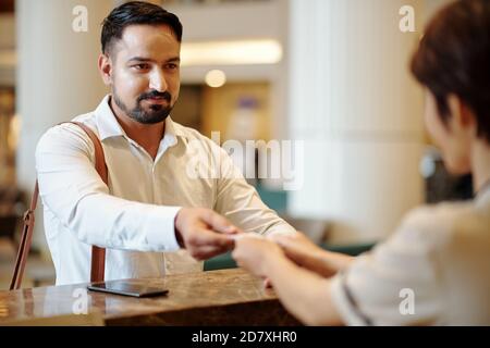 Man taking digital room key Stock Photo