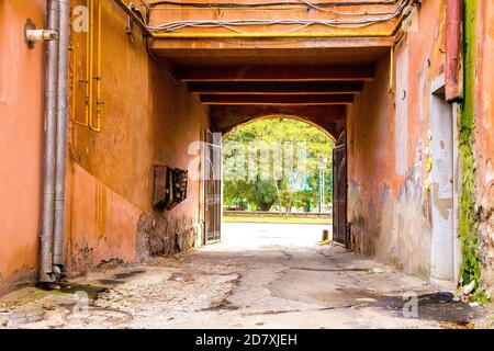 image of a walk-through arch with wrought-iron gates in an old house Stock Photo