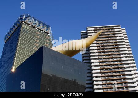 Asahi Breweries headquarters building with the Asahi Flame by french designer Philippe Starck on the east bank of the Sumida River in Sumida district, Stock Photo