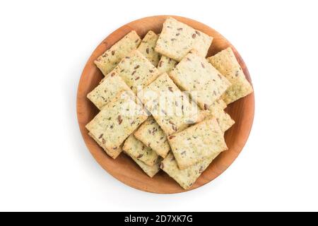 Small bread chips cookies with seeds in a wooden bowl isolated on white background. top view, close up, flat lay. Stock Photo
