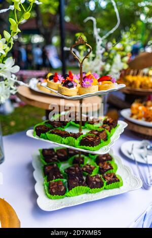 small cakes with different stuffing on party or wedding table. Selective focus. Stock Photo