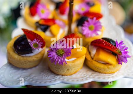 small cakes with different stuffing on party or wedding table. Selective focus. Stock Photo