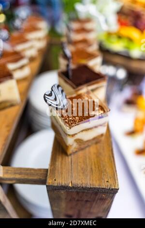 small cakes with different stuffing on party or wedding table. Selective focus. Stock Photo