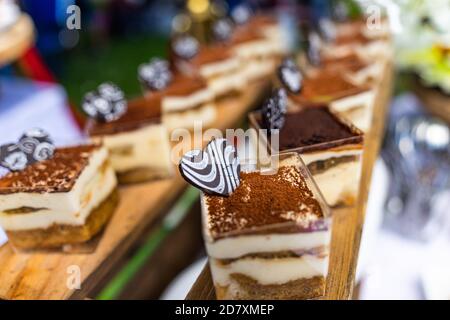 small cakes with different stuffing on party or wedding table. Selective focus. Stock Photo