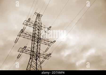 Power line mast against a gloomy gray sky. Stock Photo