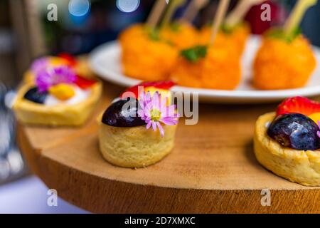 small cakes with different stuffing on party or wedding table. Selective focus. Stock Photo