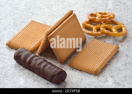Rectangular shortbread cookies and chocolates on a light marble top. Stock Photo