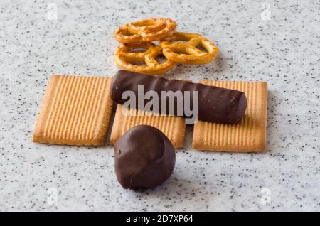 Rectangular shortbread cookies and chocolates on a light marble top. Stock Photo