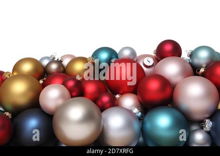 Christmas decorations, pile of glass colored balls isolated on white, useful as a greeting gift card background Stock Photo