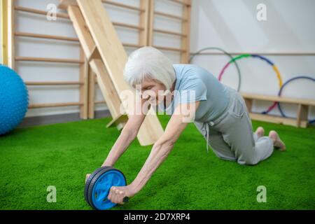 Elderly woman exercising in a rehabilitation center Stock Photo