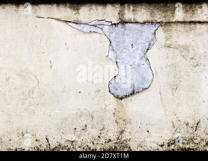 Peeling cream paint on a white concrete wall Stock Photo