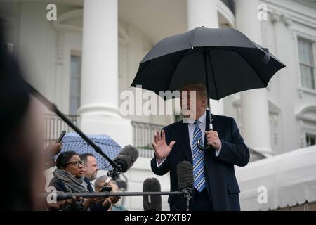 U.S. President Donald Trump speaks to reporters on the South Lawn of the White House amid the coronavirus pandemic on March 28, 2020 in Washington, D.C. Credit: Alex Edelman/The Photo Access Stock Photo