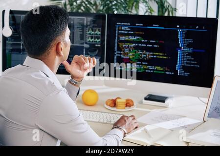 Developer checking programming code Stock Photo