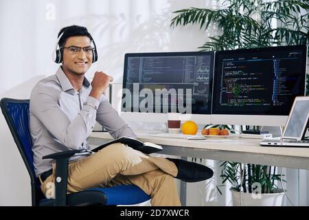 Smiling confident Indian coder Stock Photo