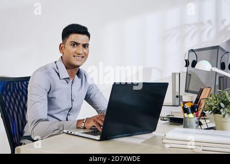 Programmer working on laptop Stock Photo