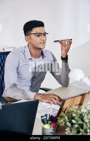Programmer recording voice message Stock Photo