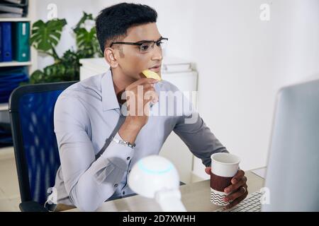 Software developer drinking coffee Stock Photo