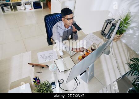 Coder recording voice message Stock Photo