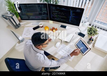 Software developer checking calendar Stock Photo