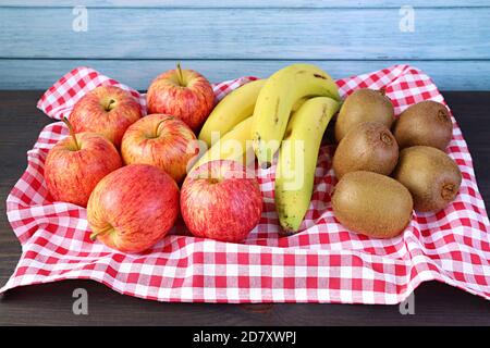 Heap of Fresh Ripe Nutritious Fruits on a Tray with Checkered Clothed on the Wooden Rustic Table Stock Photo