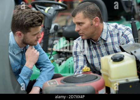 two men working in a garage Stock Photo