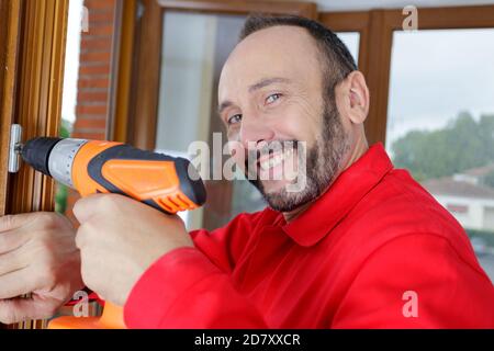 happy construction drill professional working Stock Photo