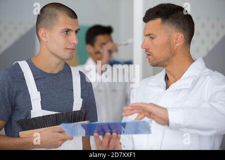 a painter with an apprentice Stock Photo
