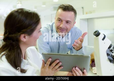 group of scientific workers taking notes making research in laboratory Stock Photo