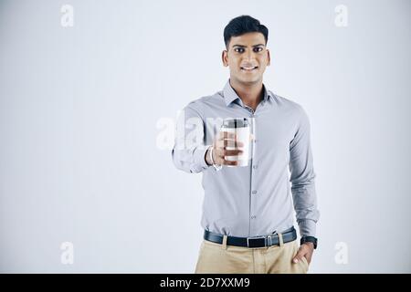 Businessman giving take away cappuccino Stock Photo