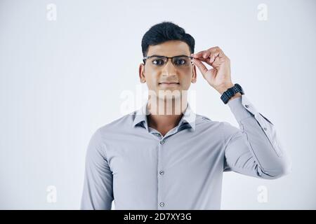 Software developer putting on glasses Stock Photo