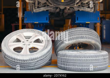 The wheels of the car are on the floor in the garage, old Tire of car in the garage change and repair concept Stock Photo