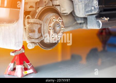 Close up Car brake part at garage, Old and dirty rear dump break of the vehicle for repair Suspension in car service. Stock Photo