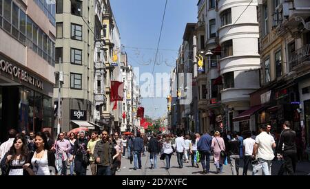 A crowd of people walk along Istiklal Caddesi in the Taksim district of Istanbul in Turkey. This is one of the main shopping districts of Istanbul. Stock Photo