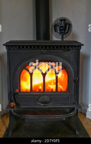 cast iron stove with small fan on top Stock Photo