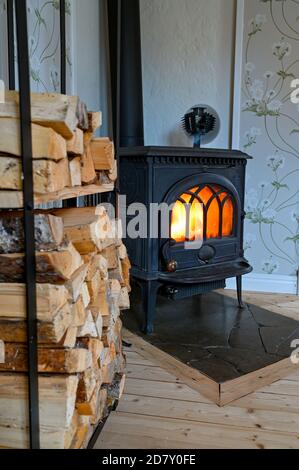 cast iron stove with small fan on top Stock Photo