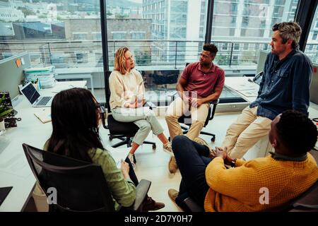 Diverse team of entrepreneurs discussing ideas for new project for new company, preparing for conference meeting  Stock Photo