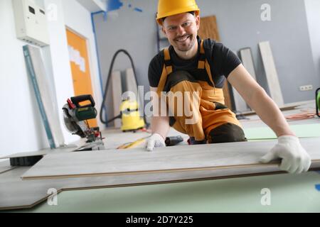 Man builder holds laminate board in his hands Stock Photo