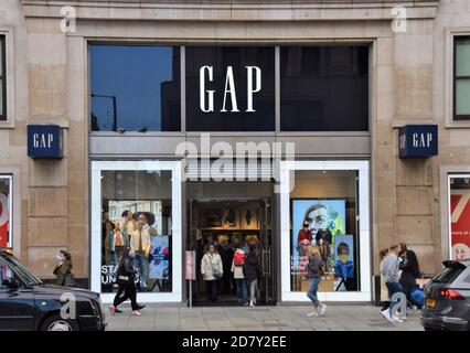 People walk past the Gap store on Oxford Street, London Stock Photo