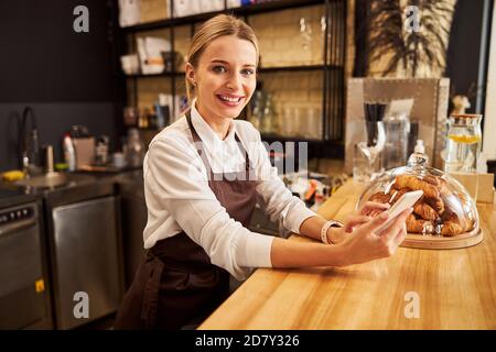 Happy cheerful female posing at the photo camera in the coffee bar Stock Photo