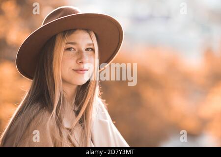 Smiling blonde teen girl 14-16 year old wearing stylish clothes posing  outdoors. Looking at camera. Autumn season Stock Photo - Alamy