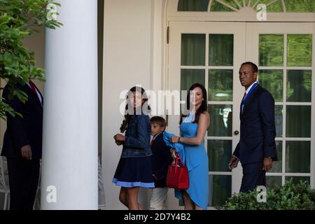 Golfer Tiger Woods accompanied by his children and girlfriend Erica Herman, follow U.S. President Donald Trump into the Oval Office after Trump awarded the Presidential Medal of Freedom to Woods in the Rose Garden of the White House in Washington, D.C. on Monday, May 6, 2019. The Presidential Medal of Freedom is the highest honor a U.S. President can bestow on a civilian. Woods is the fourth golfer to receive the award. Credit: Alex Edelman/The Photo Access Stock Photo