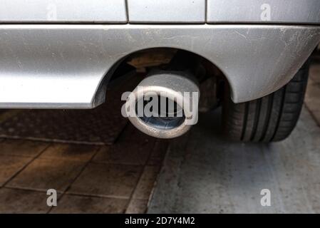 The exhaust system in the diesel car seen up close, view from rear of muffler. Stock Photo