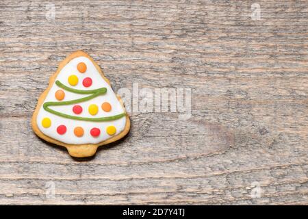 Christmas cookie in the form of tree on wooden background. Stock Photo